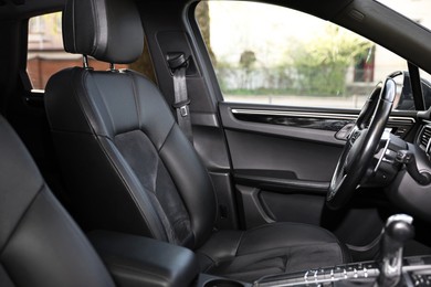 Photo of Inside of modern black car with leather seats