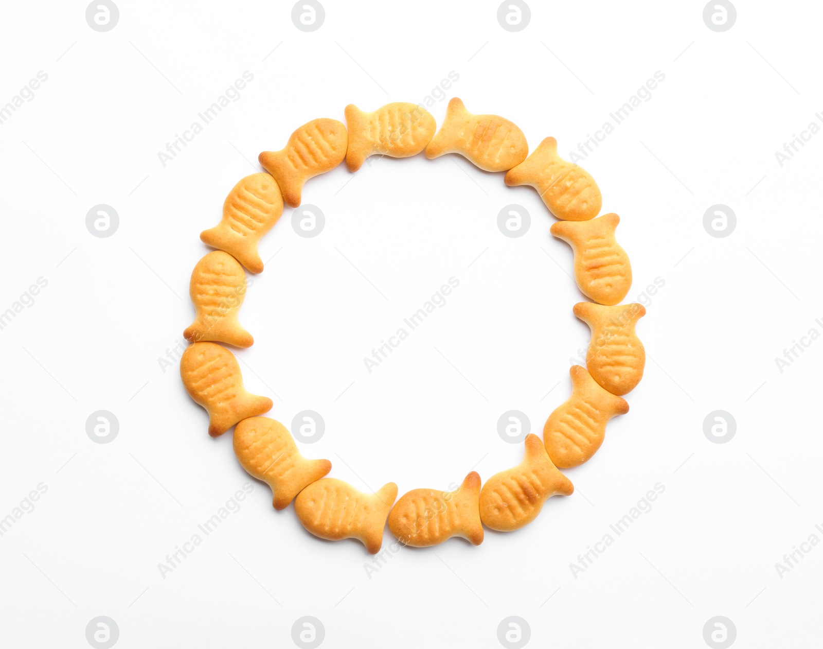 Photo of Delicious crispy goldfish crackers on white background, top view