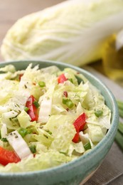 Photo of Tasty salad with Chinese cabbage in bowl on table, closeup