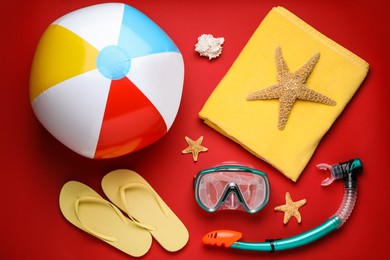 Photo of Flat lay composition with ball and beach objects on red background