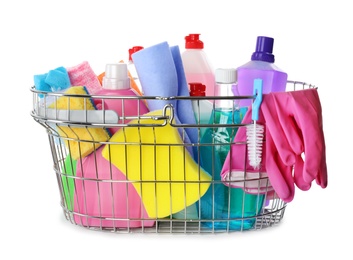 Metal shopping basket with different household chemicals on white background