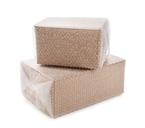 Photo of Cardboard boxes packed in bubble wrap on white background