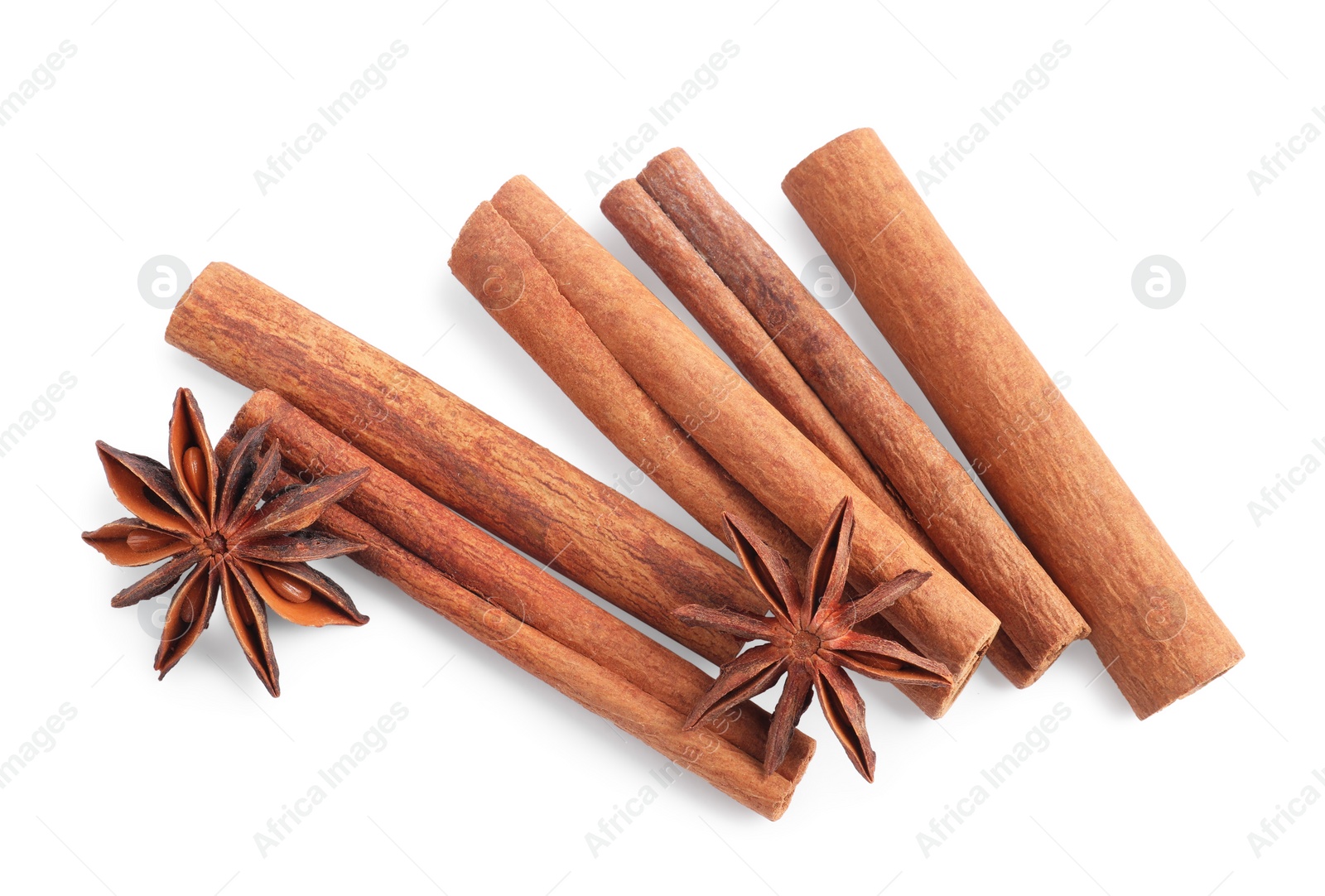 Photo of Aromatic cinnamon sticks and anise stars isolated on white, top view