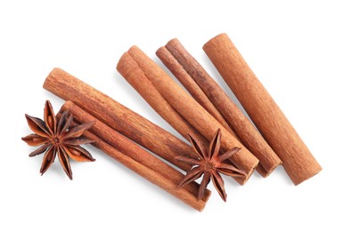 Aromatic cinnamon sticks and anise stars isolated on white, top view