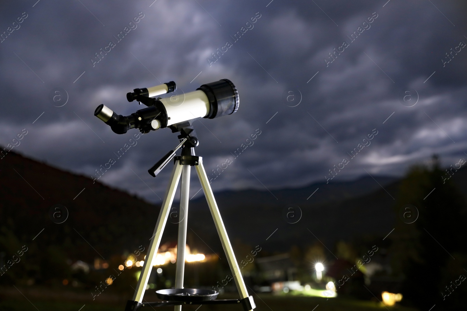 Photo of Modern new telescope and mountains in evening