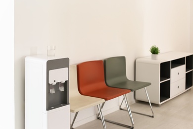 Modern water cooler in stylish office interior