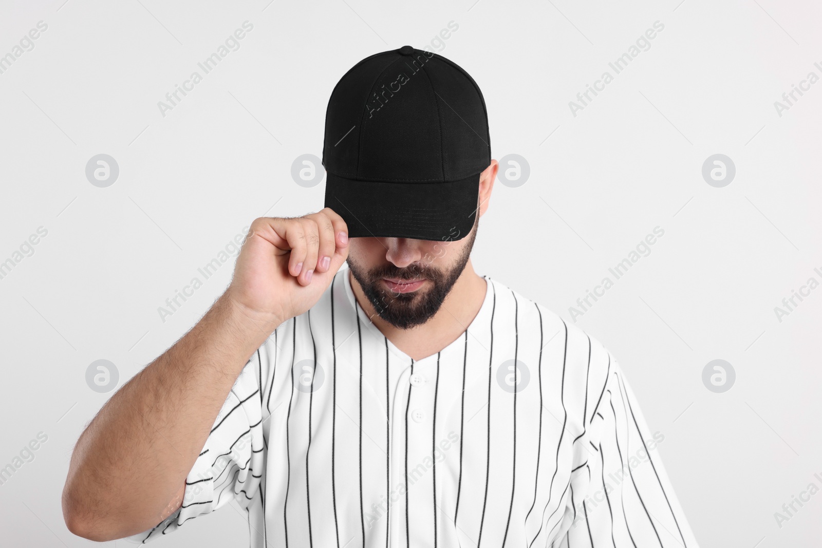 Photo of Man in stylish black baseball cap on white background