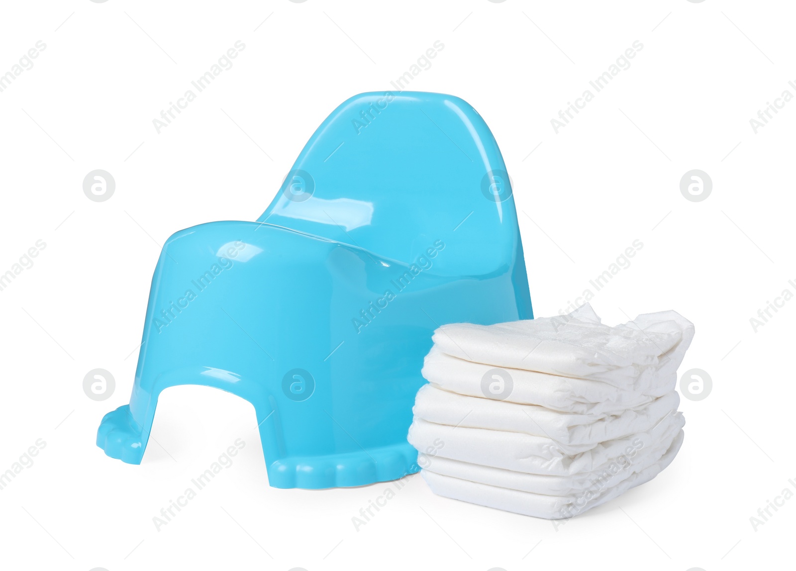 Photo of Light blue baby potty and stack of diapers isolated on white. Toilet training