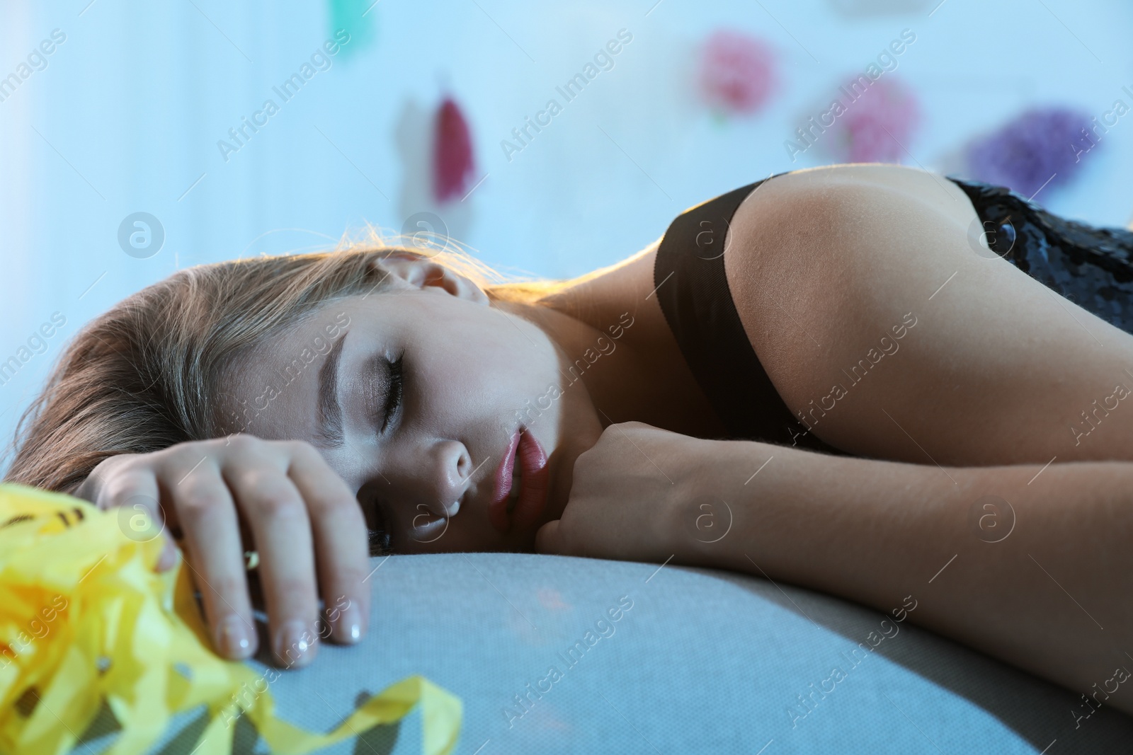 Photo of Young woman sleeping in room after party