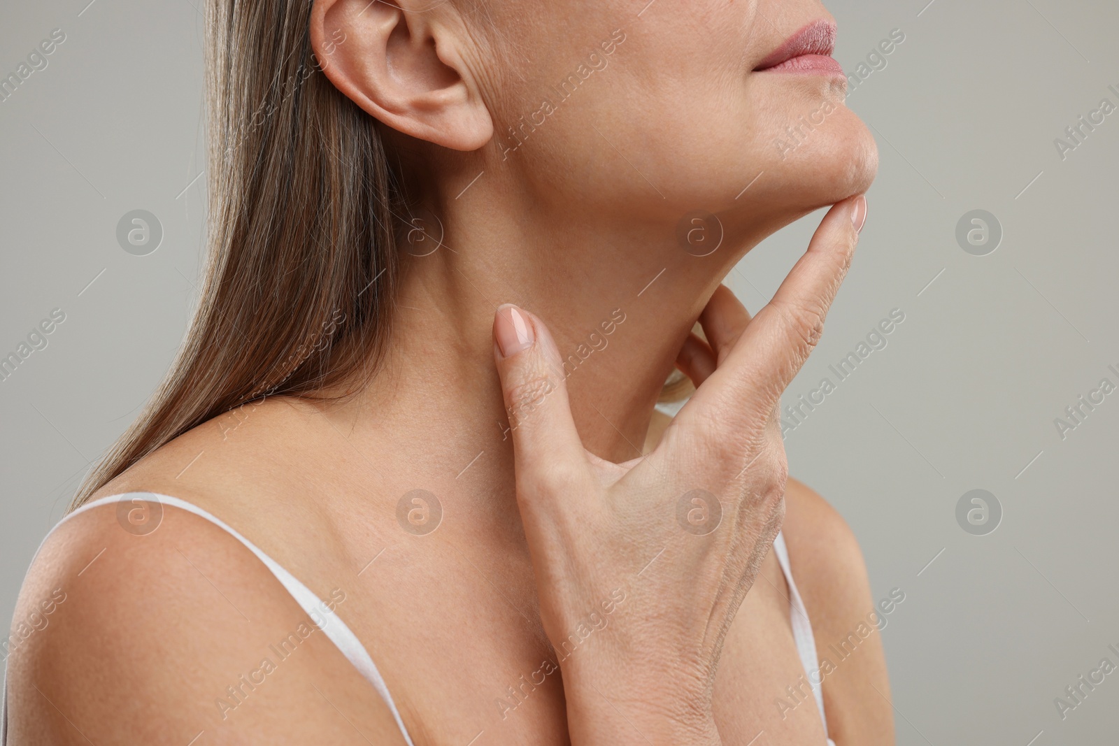 Photo of Mature woman with healthy skin on grey background, closeup