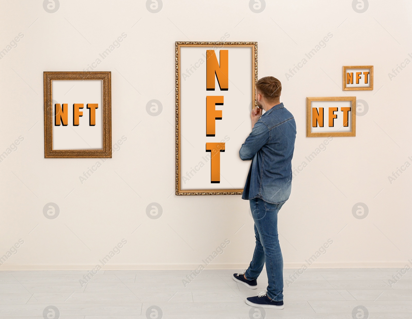 Image of Man at exhibition in gallery, back view. Pictures with abbreviations NFT