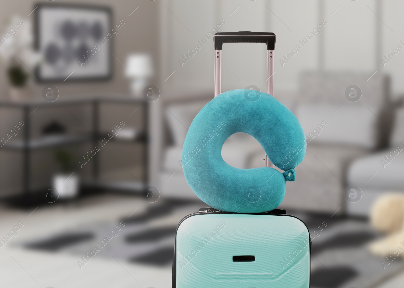 Image of Travel pillow on suitcase in room. Space for text