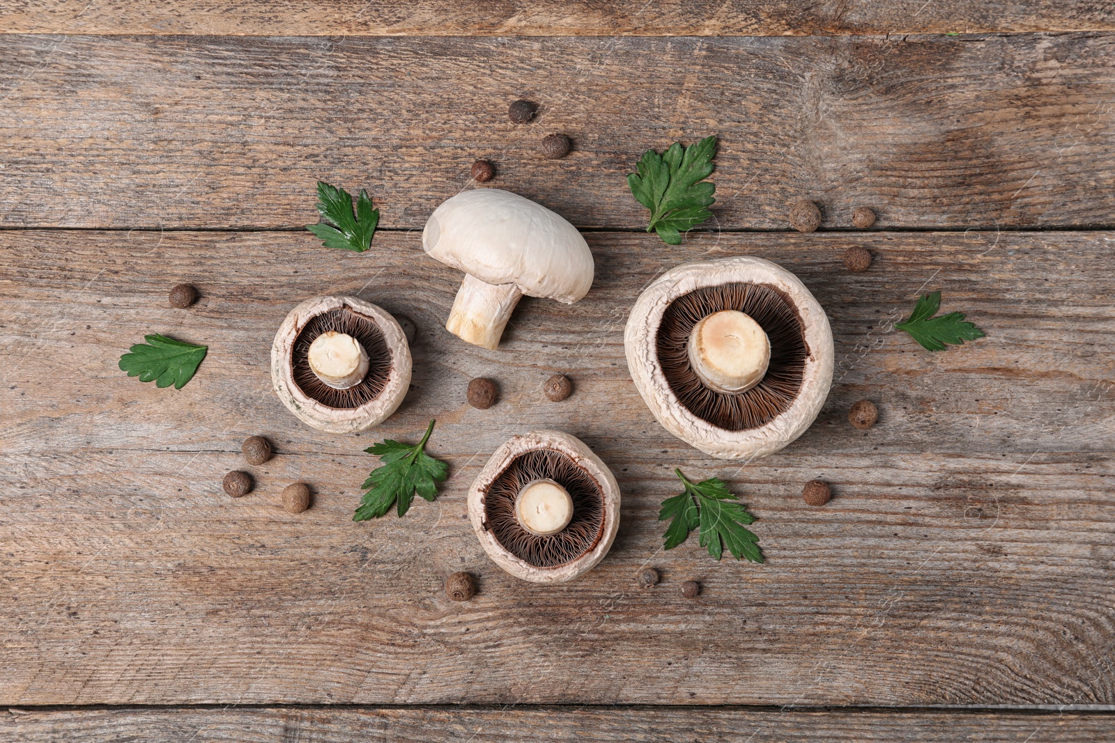 Photo of Flat lay composition with fresh champignon mushrooms on wooden background