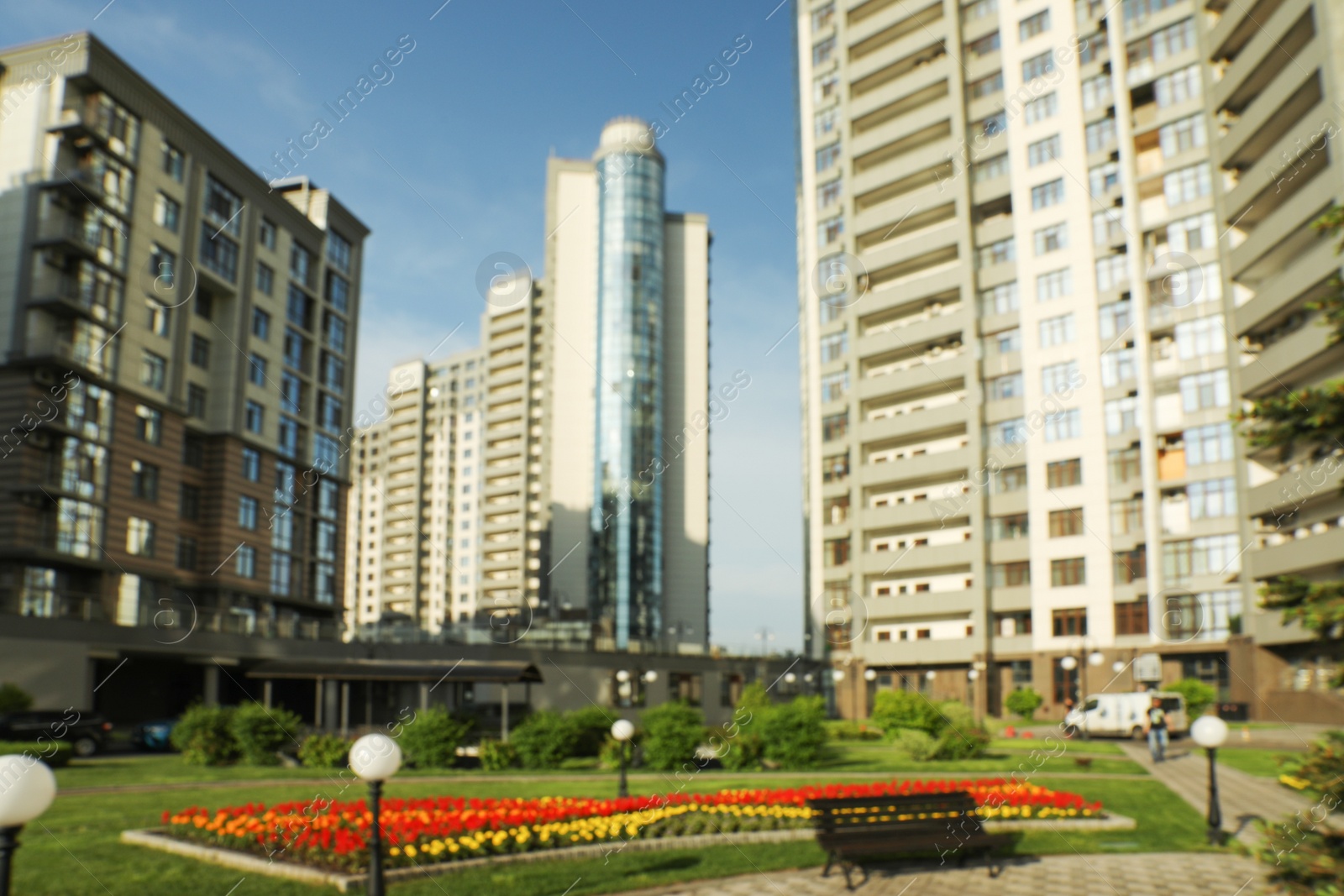 Photo of KYIV, UKRAINE - MAY 21, 2019: Blurred view of modern housing estate in Pecherskyi district on sunny day