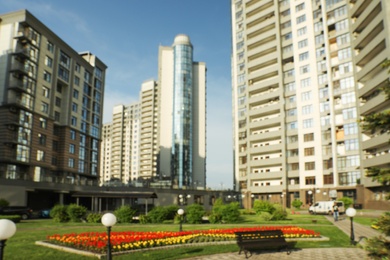 Photo of KYIV, UKRAINE - MAY 21, 2019: Blurred view of modern housing estate in Pecherskyi district on sunny day