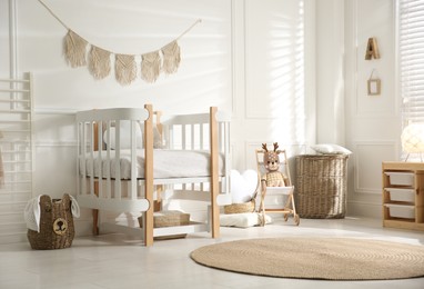 Baby room interior with stylish furniture and toys