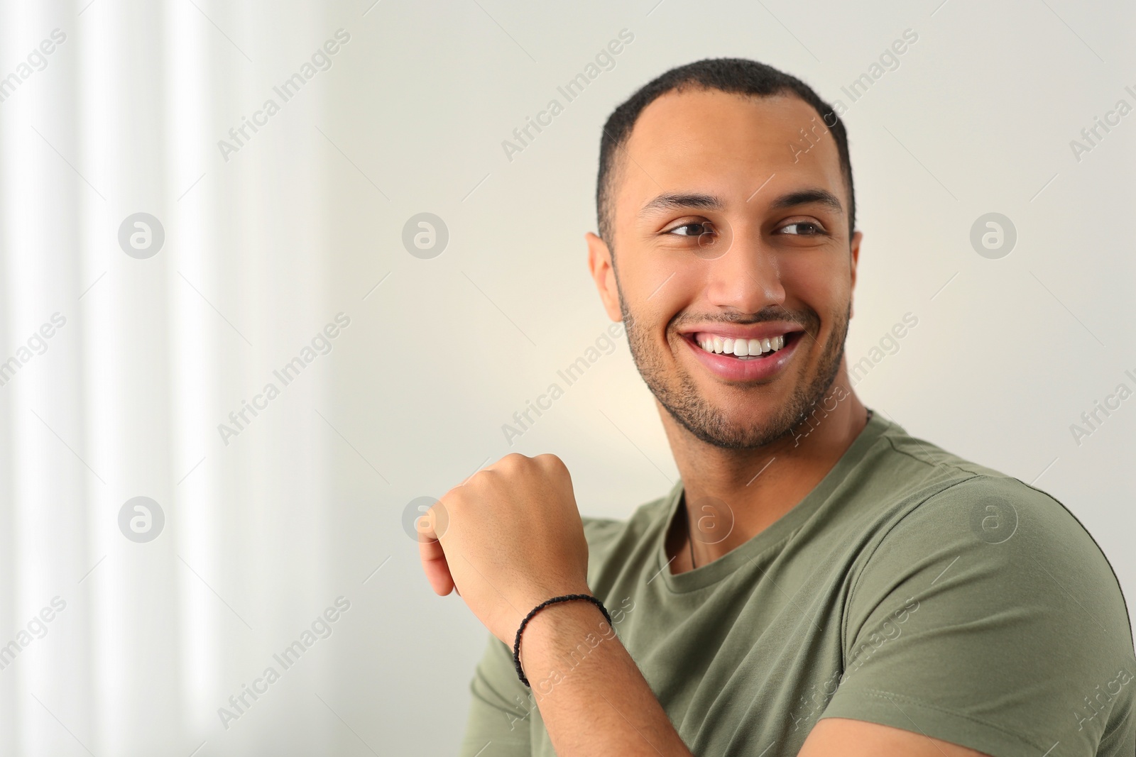 Photo of Portrait of smiling African American man at home. Space for text