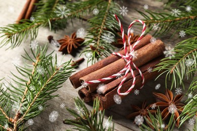 Different spices and fir tree branches on wooden table. Cinnamon, anise, cloves