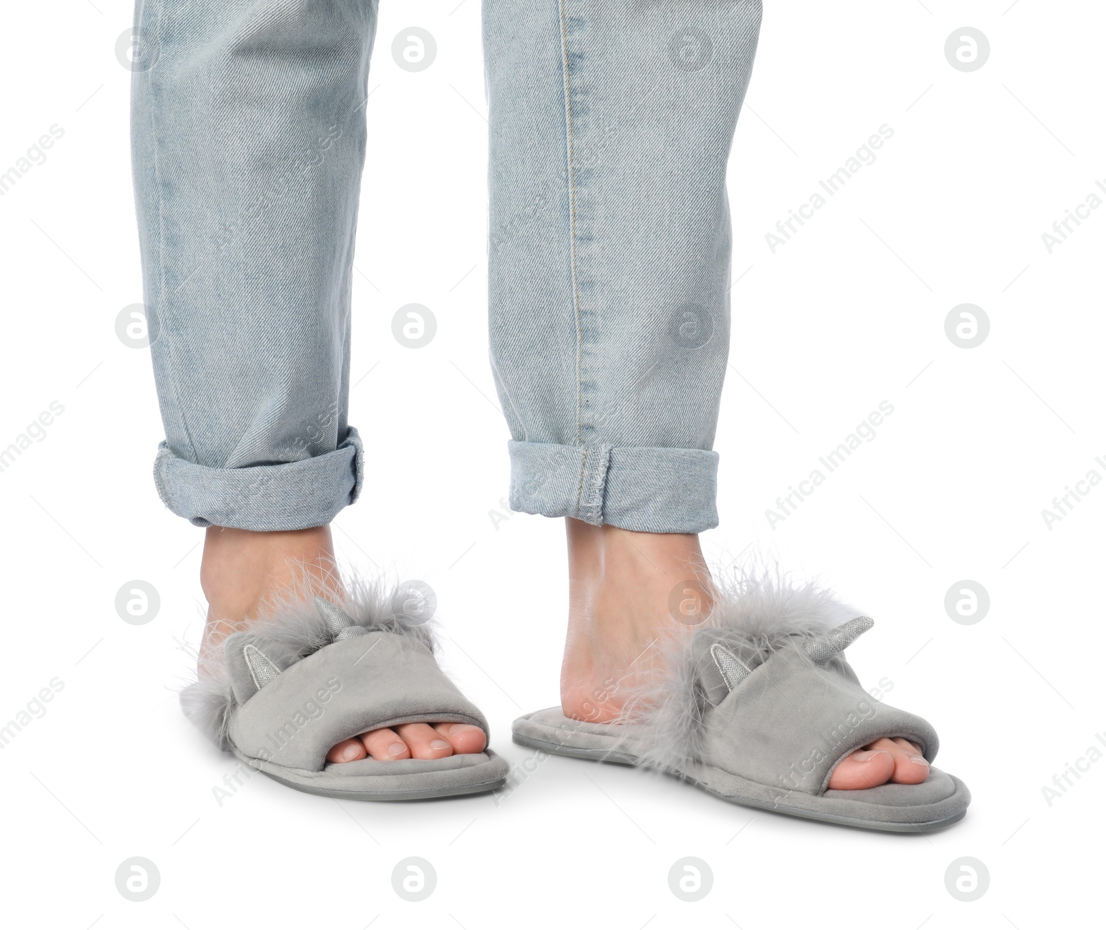 Photo of Woman in grey soft slippers on white background, closeup