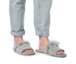 Photo of Woman in grey soft slippers on white background, closeup