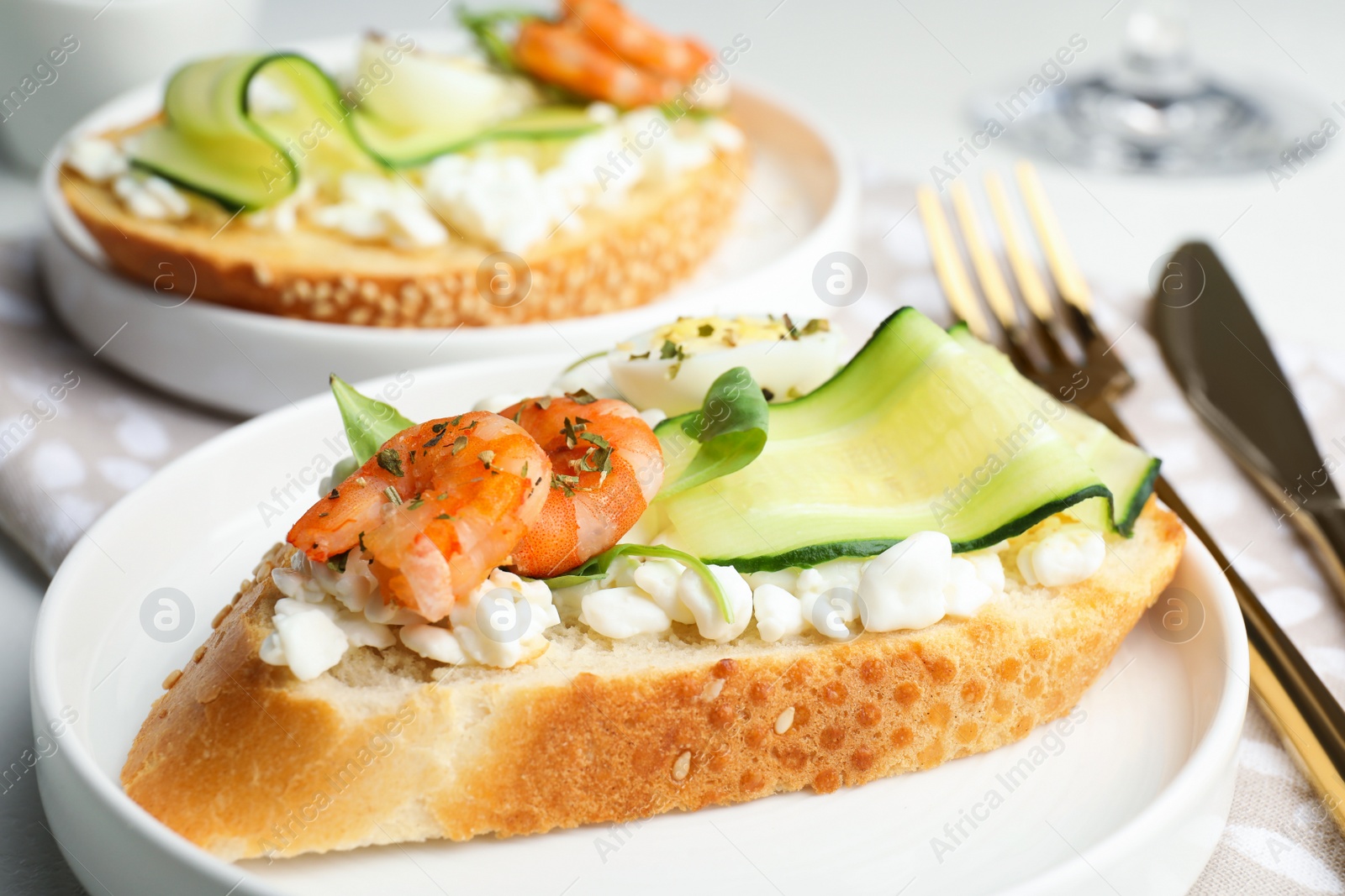 Photo of Delicious bruschettas with shrimps served on white table, closeup