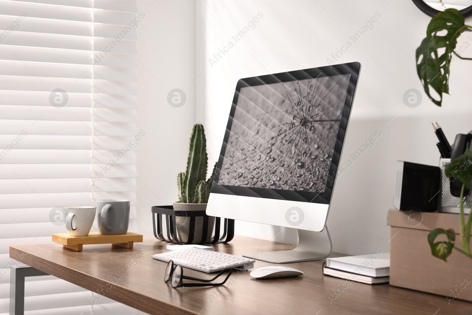 Photo of Cozy workspace with computer on wooden desk at home