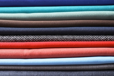 Photo of Stack of colorful fabrics as background