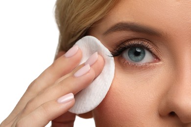 Photo of Woman removing makeup with cotton pad on white background, closeup