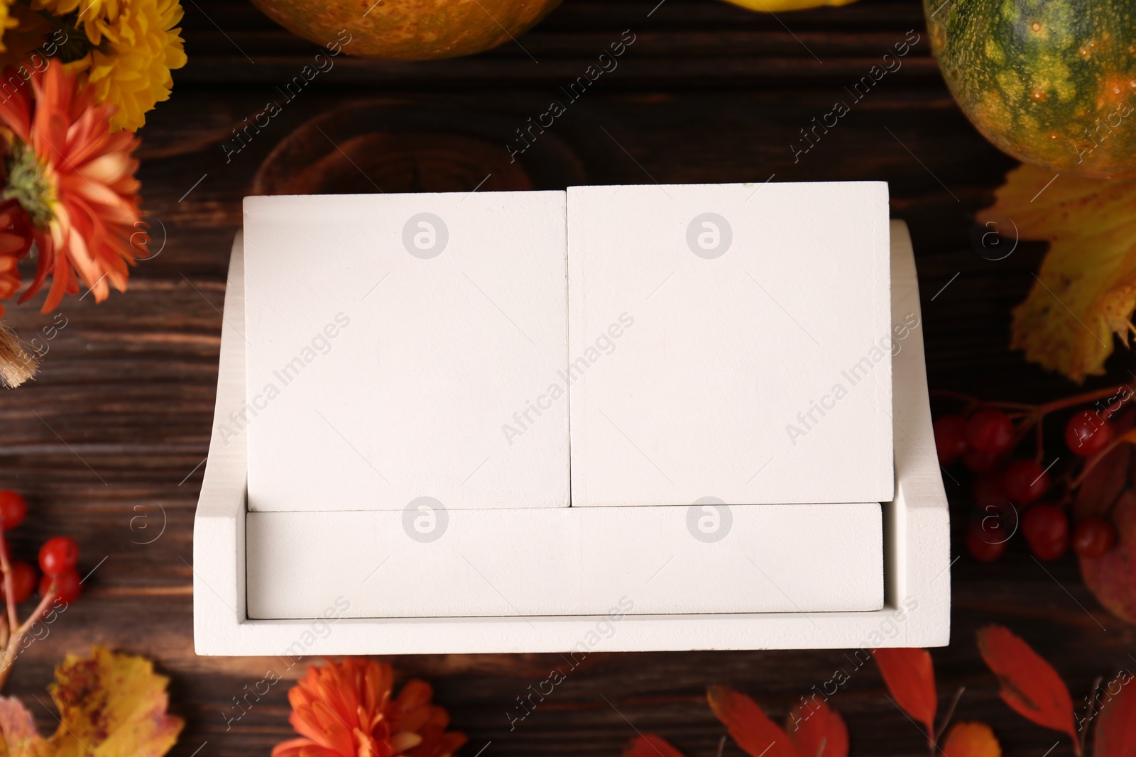 Photo of Thanksgiving day, holiday celebrated every fourth Thursday in November. Block calendar and autumn leaves on wooden table, flat lay