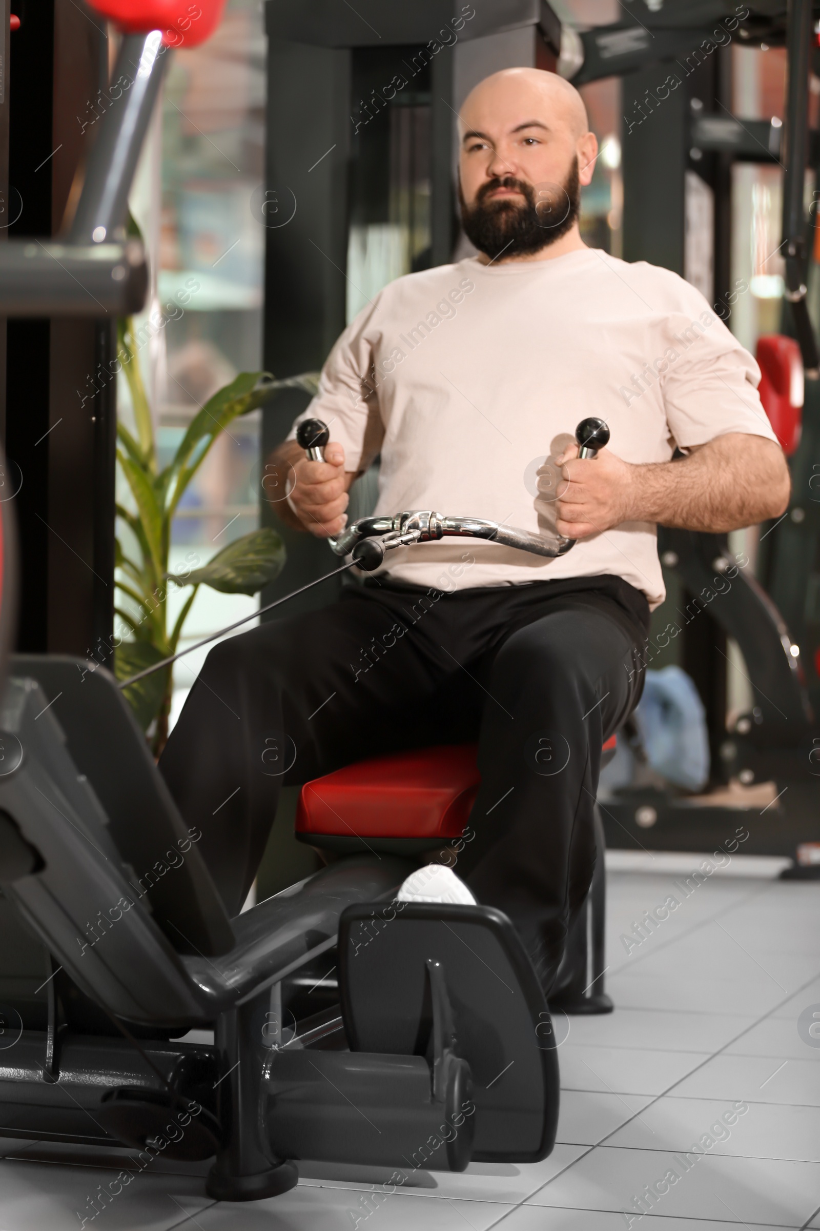 Photo of Overweight man training in gym