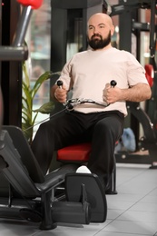 Photo of Overweight man training in gym