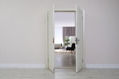 Photo of Stylish room interior, view through open door. Space for text