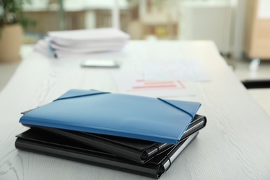 Photo of Stack of folders with documents on office table. Space for text