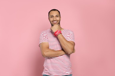 Photo of Portrait of happy African American man on pink background
