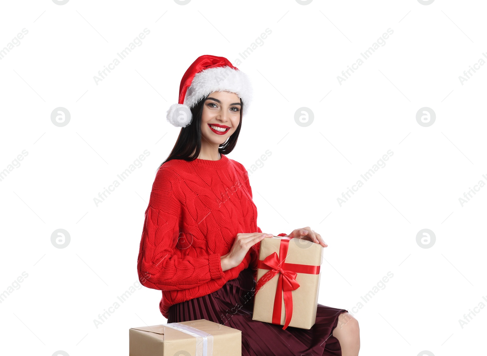 Photo of Woman in red sweater and Santa hat with Christmas gifts on white background