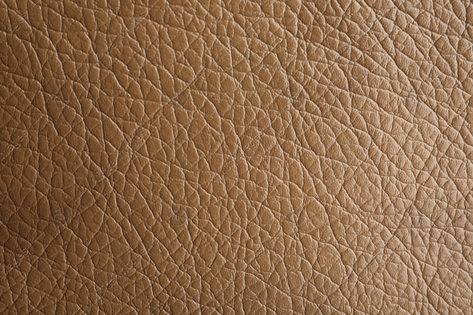 Photo of Texture of light brown leather as background, closeup