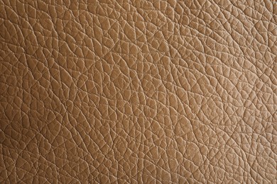 Photo of Texture of light brown leather as background, closeup