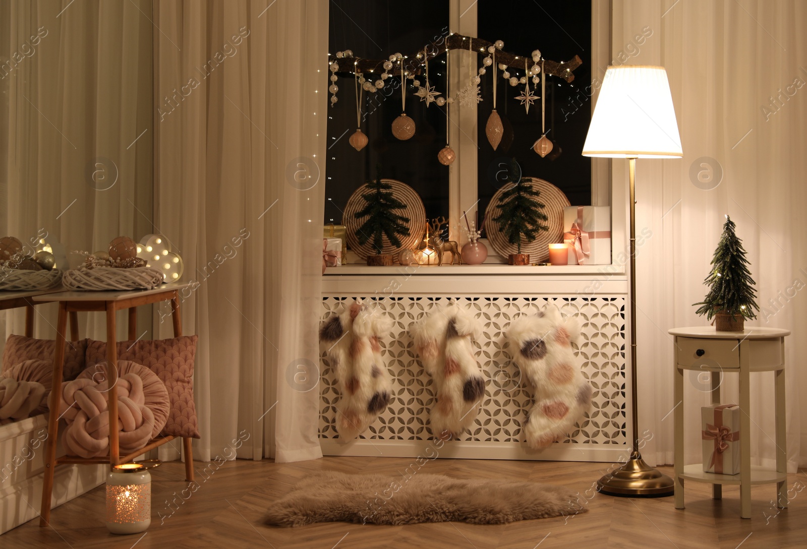 Photo of Beautiful room interior with small fir trees in evening. Christmas decor