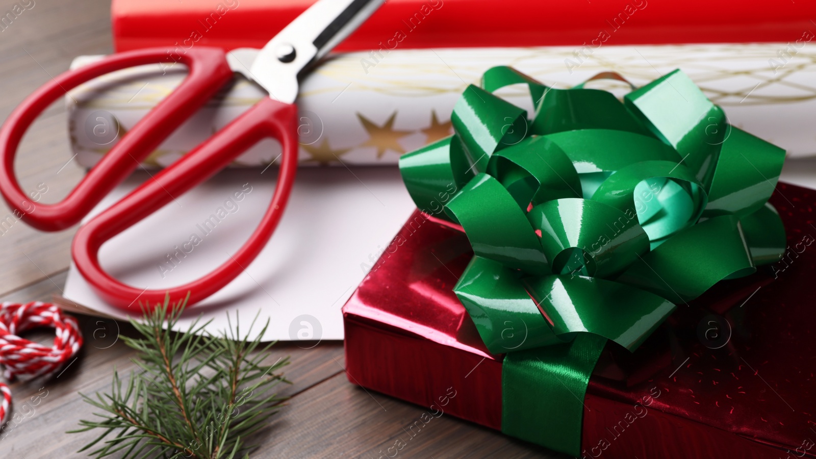 Photo of Beautifully wrapped gift box on wooden table, closeup