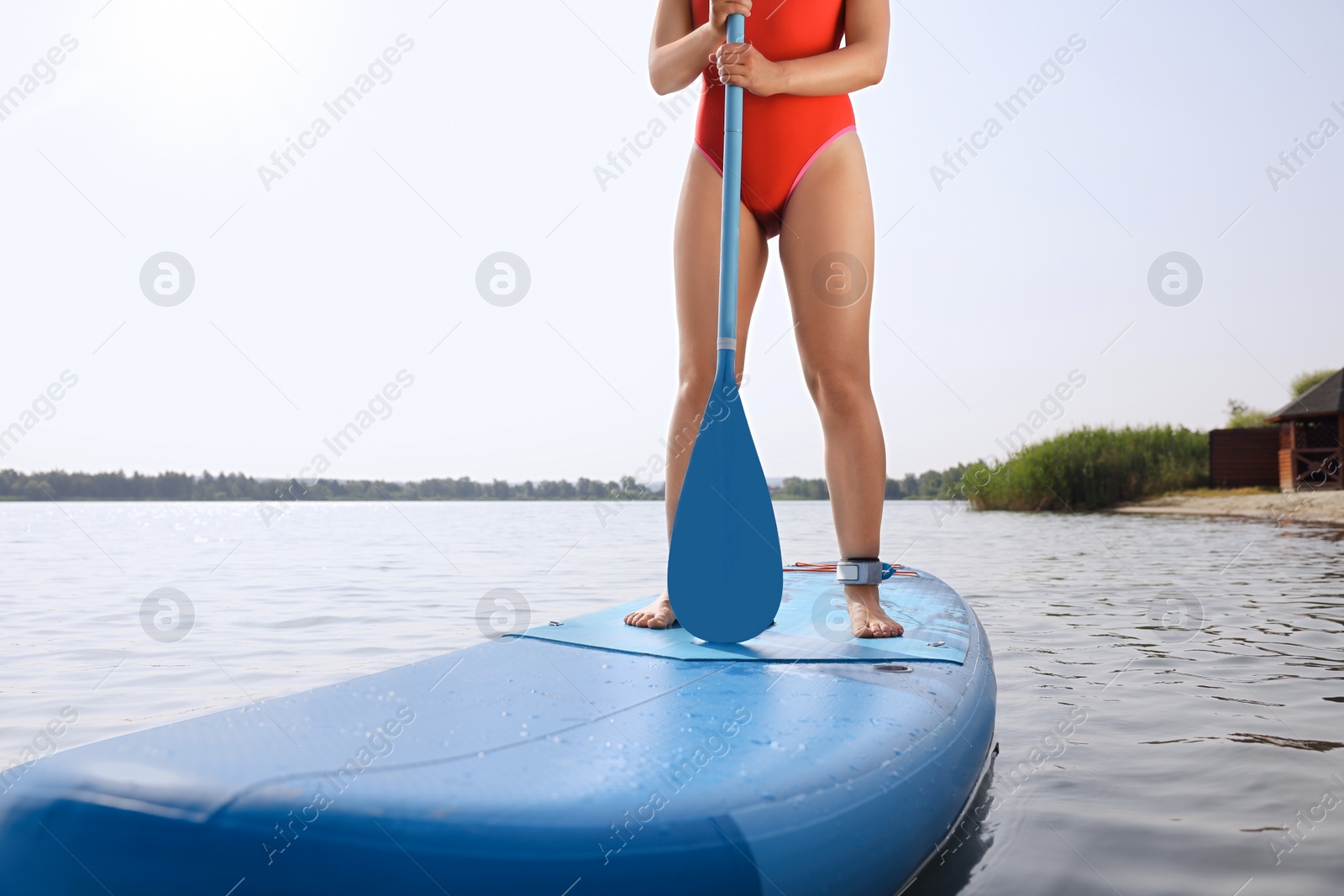 Photo of Woman paddle boarding on SUP board in sea, closeup