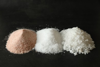 Photo of Different types of organic salt on black table