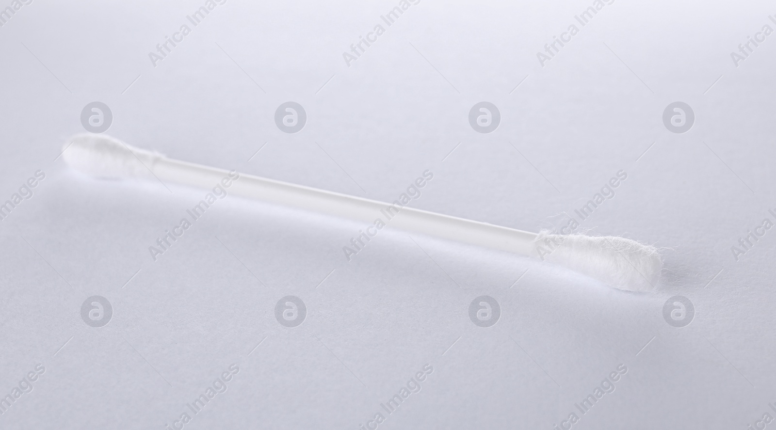 Photo of Clean cotton bud isolated on white. Hygienic accessory