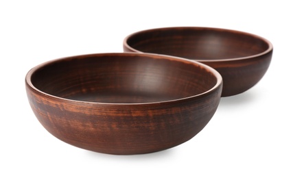 Stylish brown clay bowls on white background