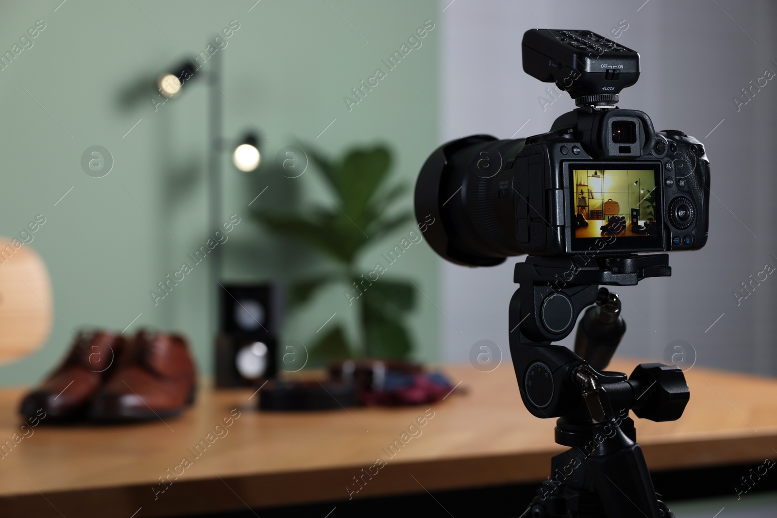 Photo of Beauty blogger's workplace. Men's accessories on table indoors, focus on camera