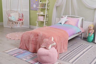 Photo of Cute child's room interior with toys and modern furniture