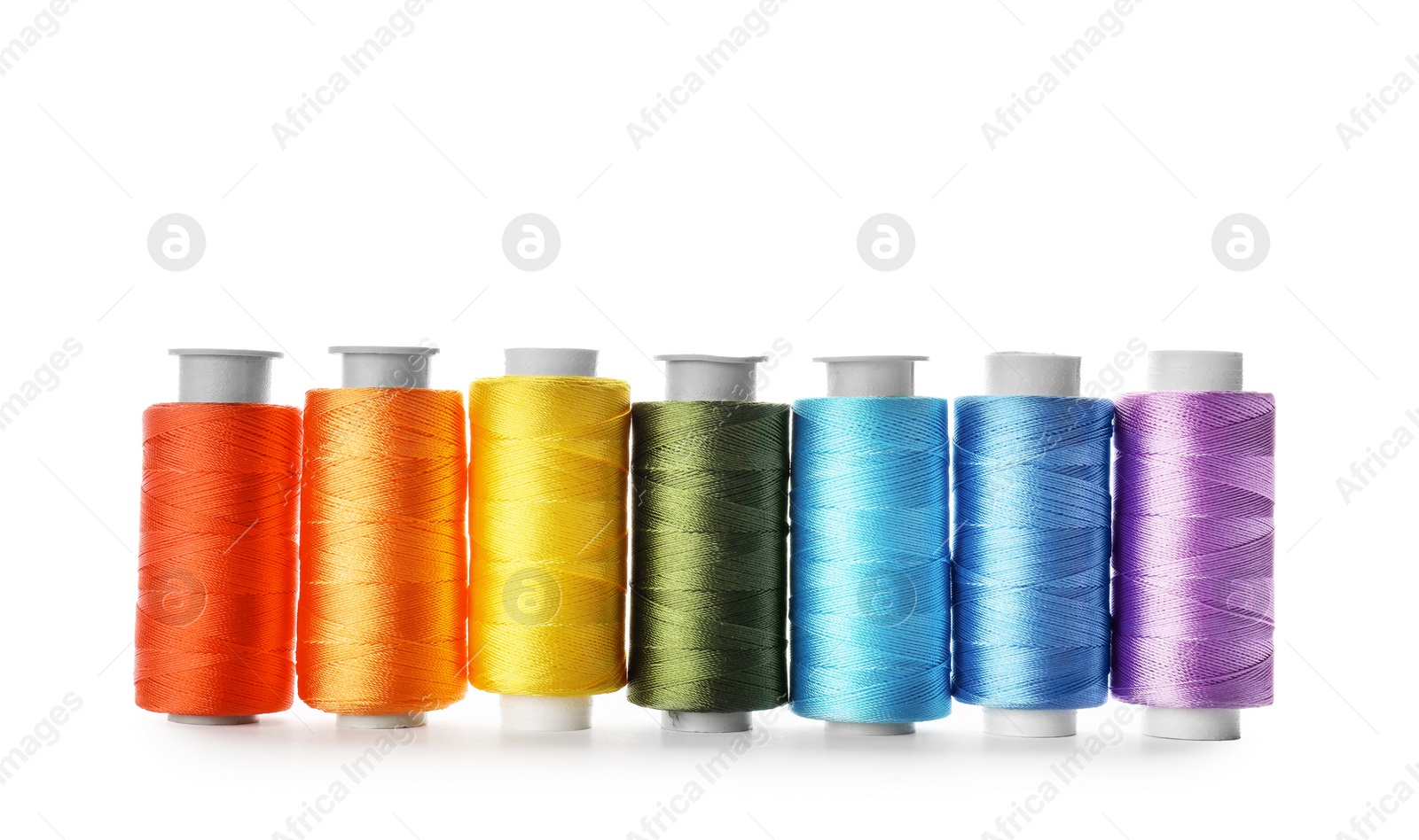 Photo of Color sewing threads on white background