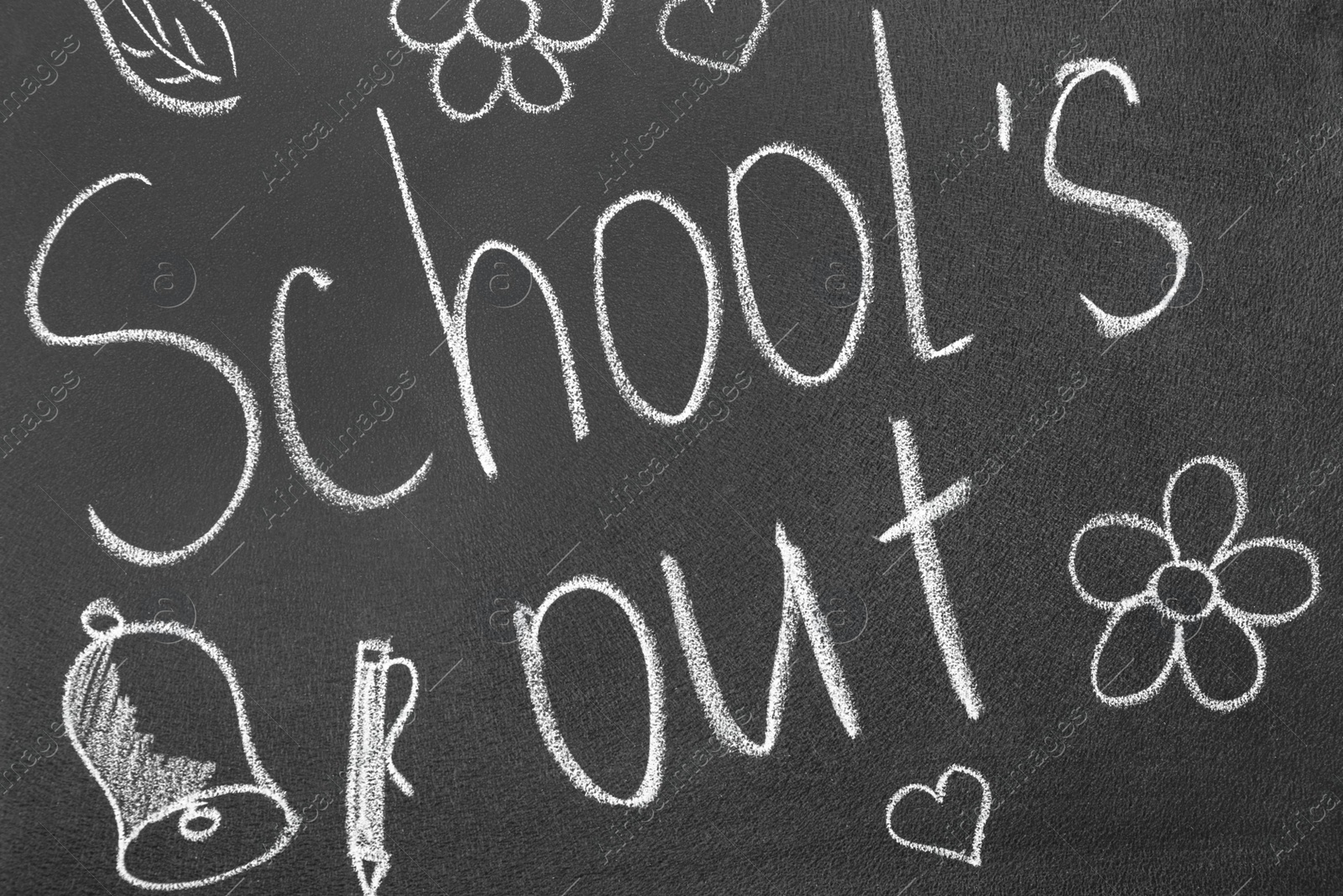 Photo of Words School's Out and pictures on blackboard. Summer holidays