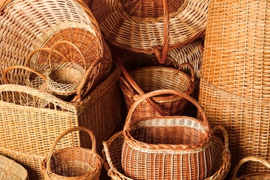 Many different wicker baskets made of natural material as background