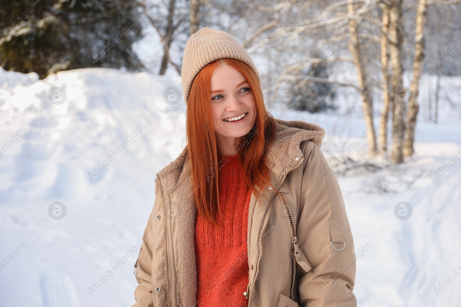 Photo of Portrait of beautiful young woman on snowy day outdoors. Winter vacation