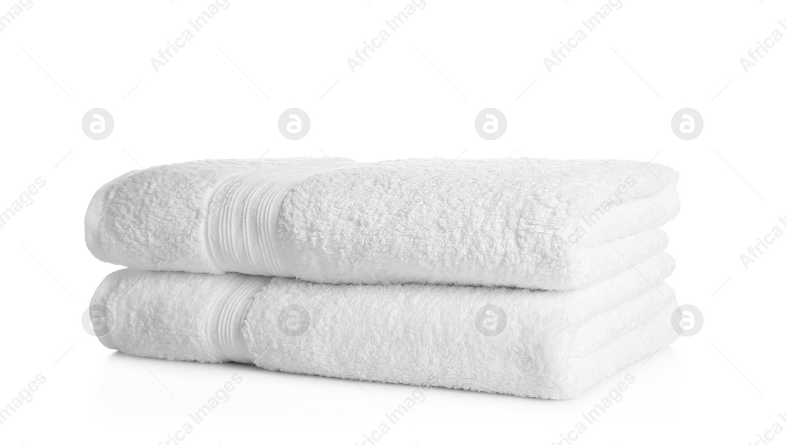 Photo of Stack of clean soft towels on white background